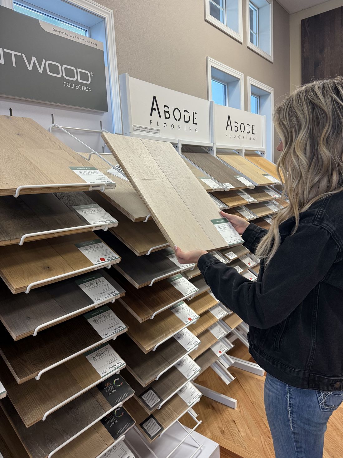 A customer comparing wood-look plank samples in the Premiere Floors design center in Puyallup