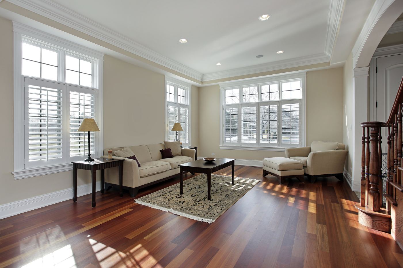 Sunlit living room with rich hardwood floors