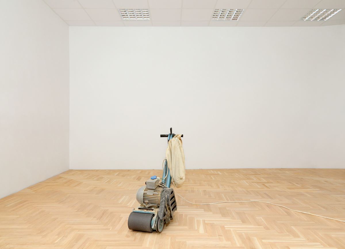 Floor sander refinishing a hardwood floor