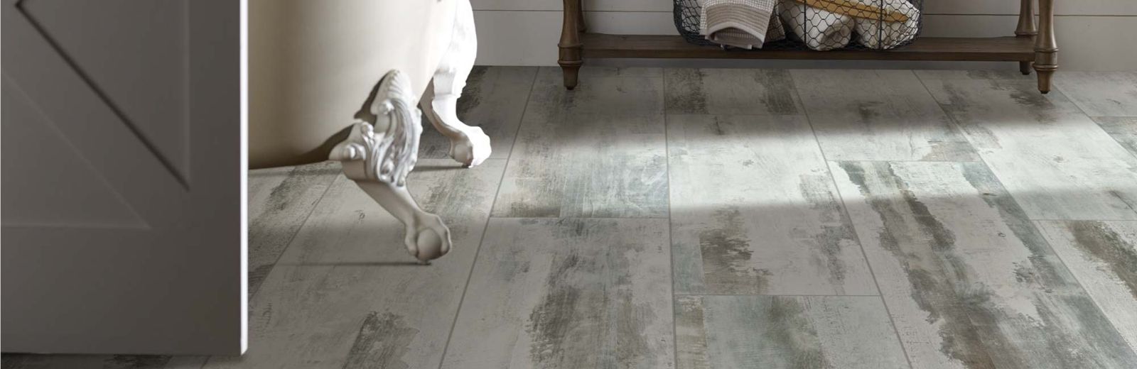 Rustic luxury vinyl plank in a bathroom with a clawfoot tub