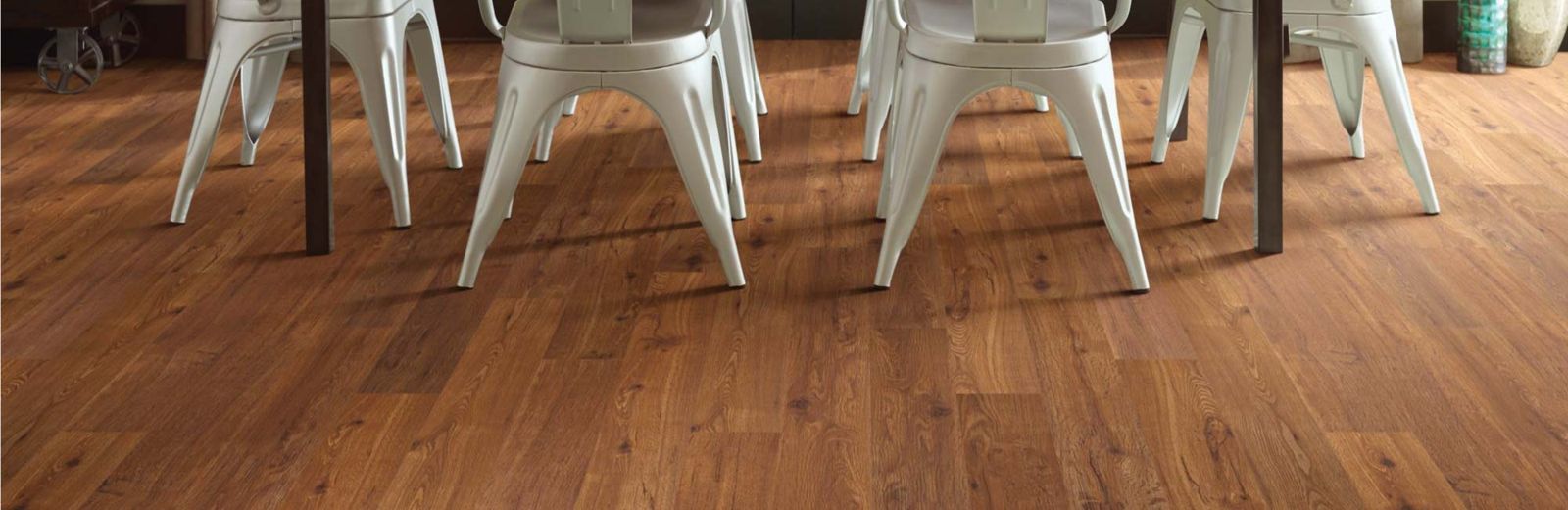 Warm wood-look luxury vinyl plank under a dining table
