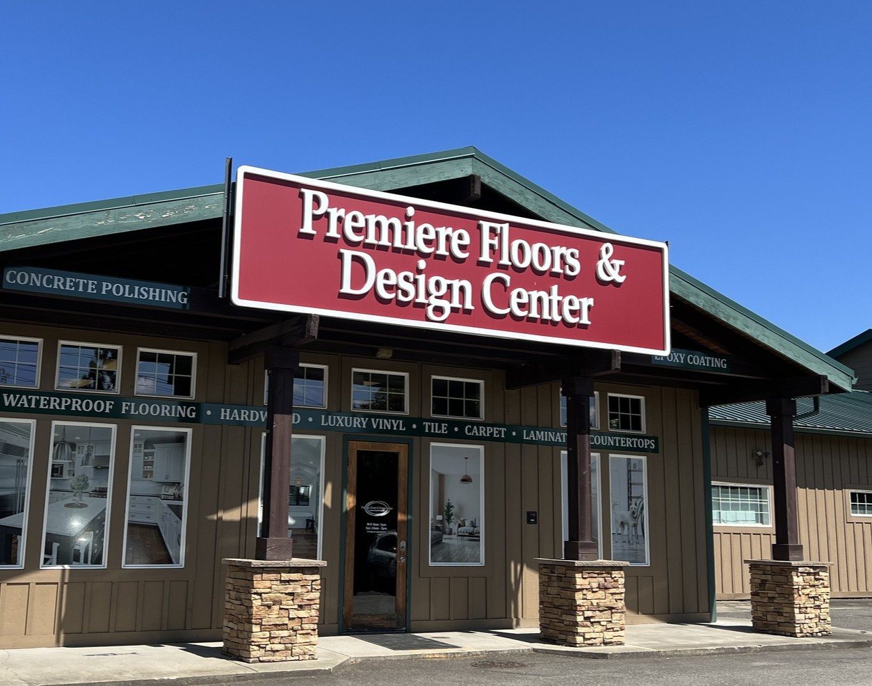 Front of the Premiere Floors & Design Center showroom on Canyon Road E in Puyallup, with its red and white sign